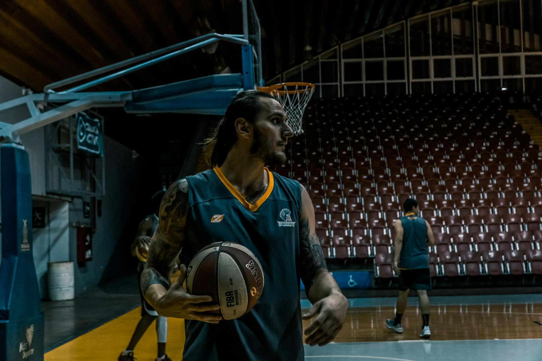 Basketball players practicing on an indoor court