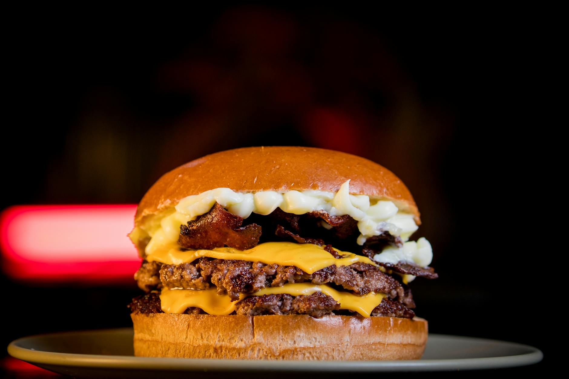 Double cheeseburger with bacon and melted cheese on a plate